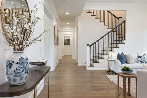 a large kitchen with kitchen island a sink appliances and cabinets