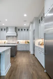 a bathroom with a double vanity sink mirror and bathtub