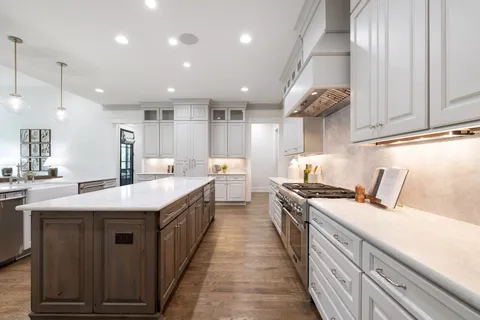 a white bath tub sitting in a bathroom next to a window