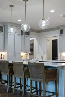 a bedroom with a large bed and a potted plant