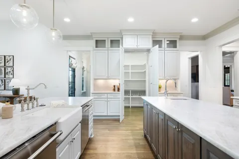 a bathroom with a granite countertop sink a toilet and a large mirror