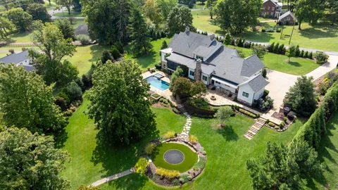 a view of a dining room with furniture a chandelier and wooden floor
