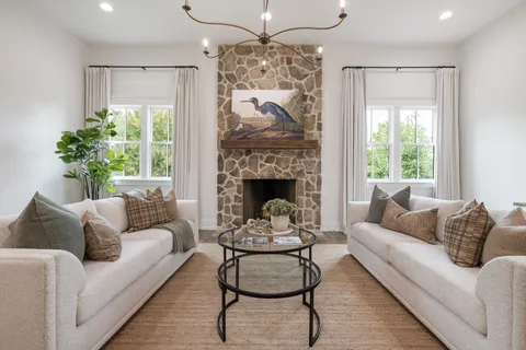 a bathroom with a granite countertop toilet a sink and a window