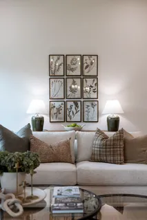 a living room with furniture and floor to ceiling windows