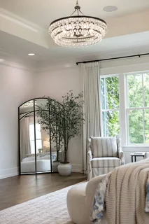 a spacious bedroom with a large bed and a flat screen tv