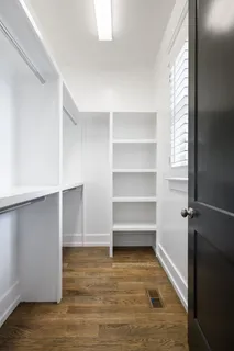 a view of backyard with table and chairs with plants and wooden fence
