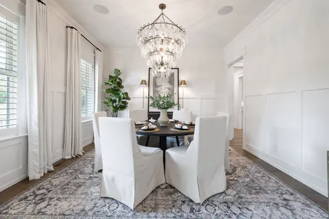 a living room with furniture a fireplace and a chandelier
