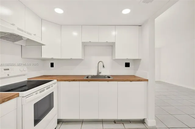 a view of a kitchen with sink and washing machine