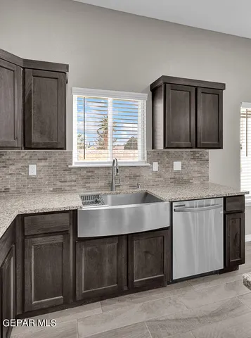 a kitchen with stainless steel appliances granite countertop a sink stove and cabinets