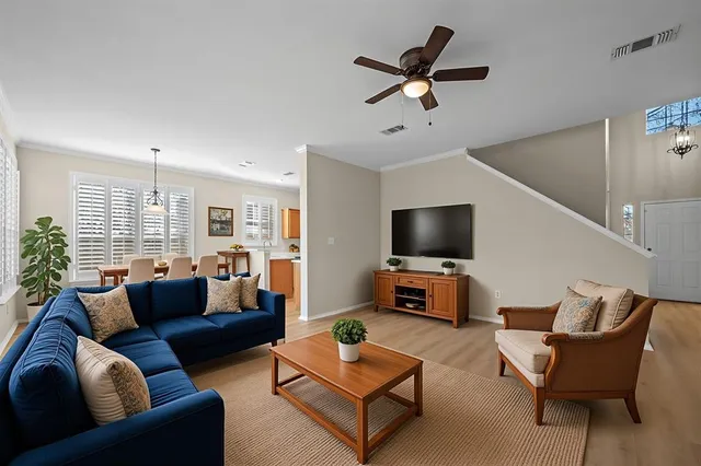 a view of a hallway with windows and chandelier