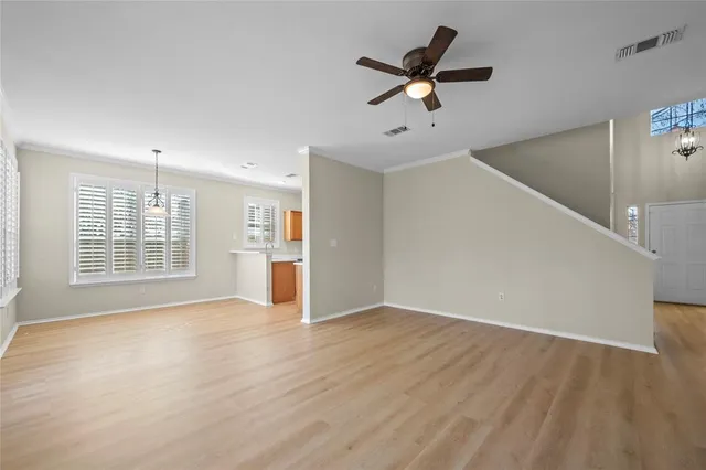 a spacious bedroom with a bed a couch and a flat screen tv