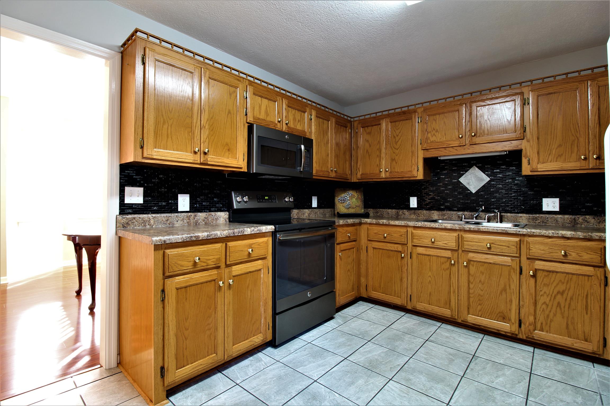 176 Simons Boulevard Morrison, TN 37357 - Photo 7 of 21 a kitchen with granite countertop a sink stainless steel appliances and cabinets