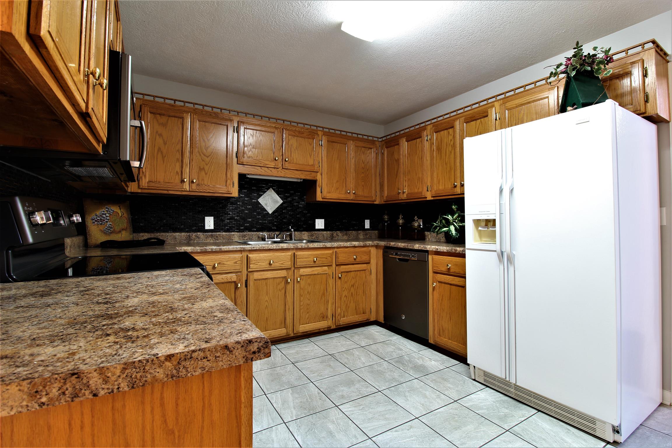 176 Simons Boulevard Morrison, TN 37357 - Photo 8 of 21 a kitchen with a sink a refrigerator and cabinets