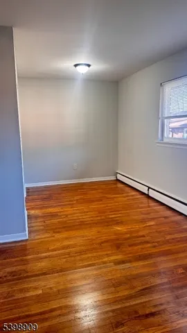 a view of room with wooden floor