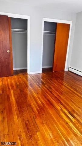 a view of an empty room with closet and a window