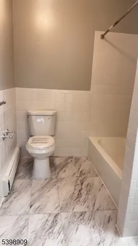 a bathroom with a toilet and a bathtub