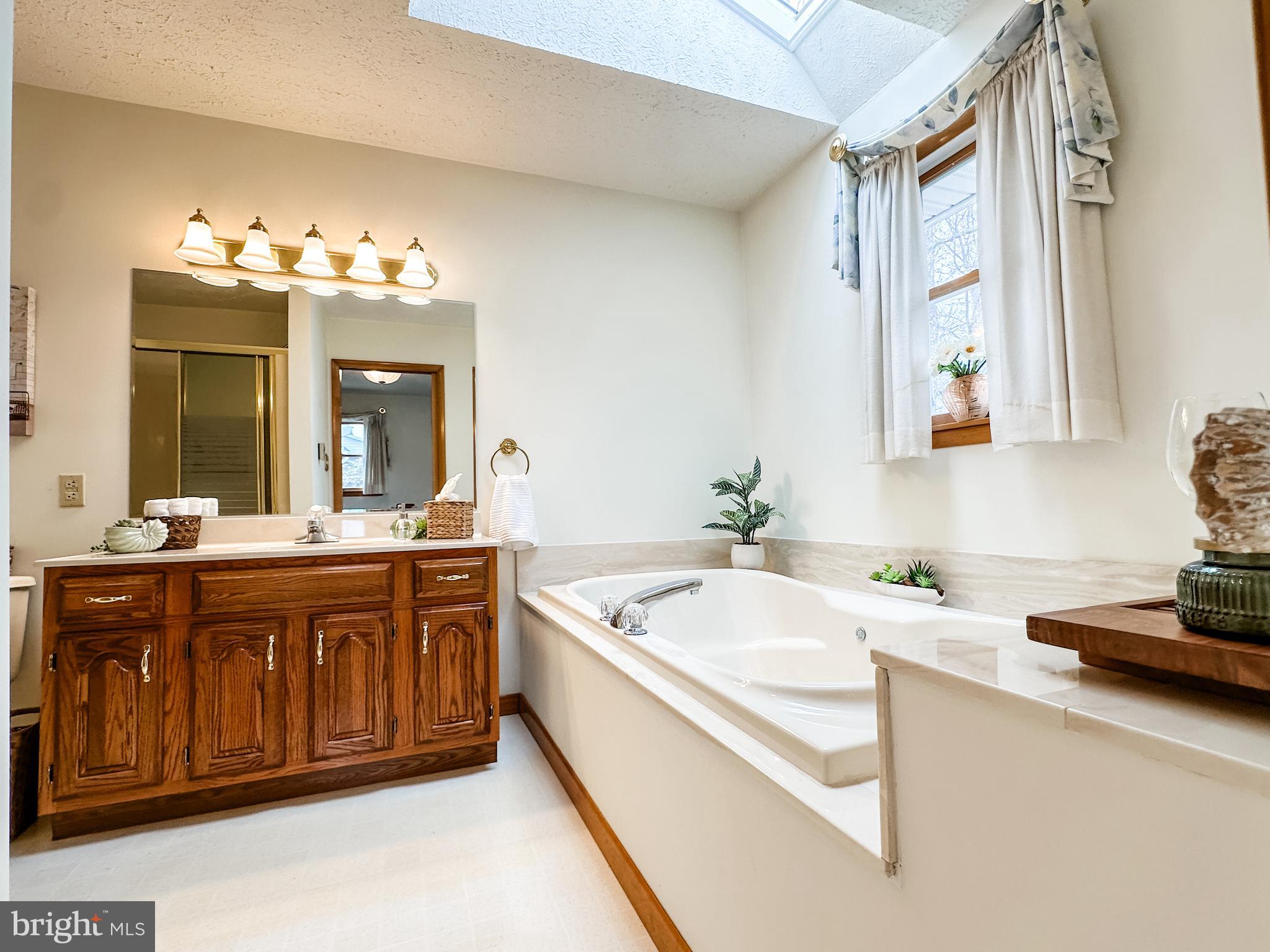 14907 Viewcrest Road Southwest Cumberland, MD 21502 - Photo 15 of 36 a spacious bathroom with a granite countertop tub sink and mirror