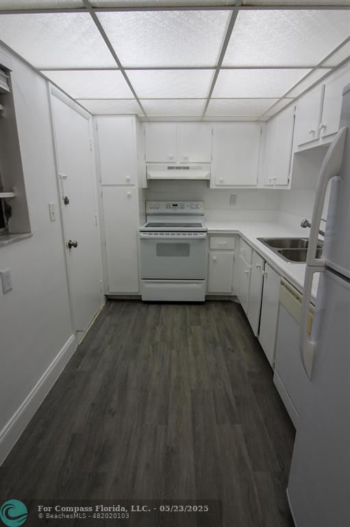 9159 Southwest 77th Avenue, Unit 411 Miami, FL 33156 - Photo 1 of 18 a kitchen with a sink and cabinets