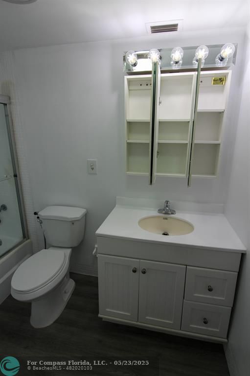 9159 Southwest 77th Avenue, Unit 411 Miami, FL 33156 - Photo 14 of 18 a bathroom with a toilet sink and mirror