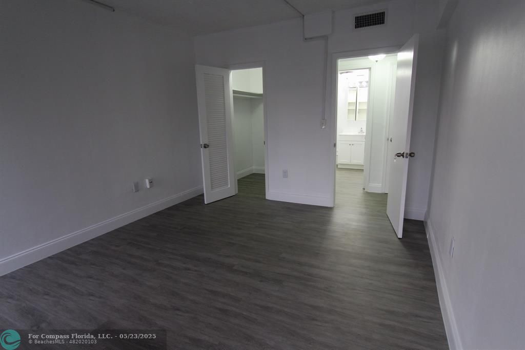 9159 Southwest 77th Avenue, Unit 411 Miami, FL 33156 - Photo 16 of 18 a view of a hallway with wooden floor