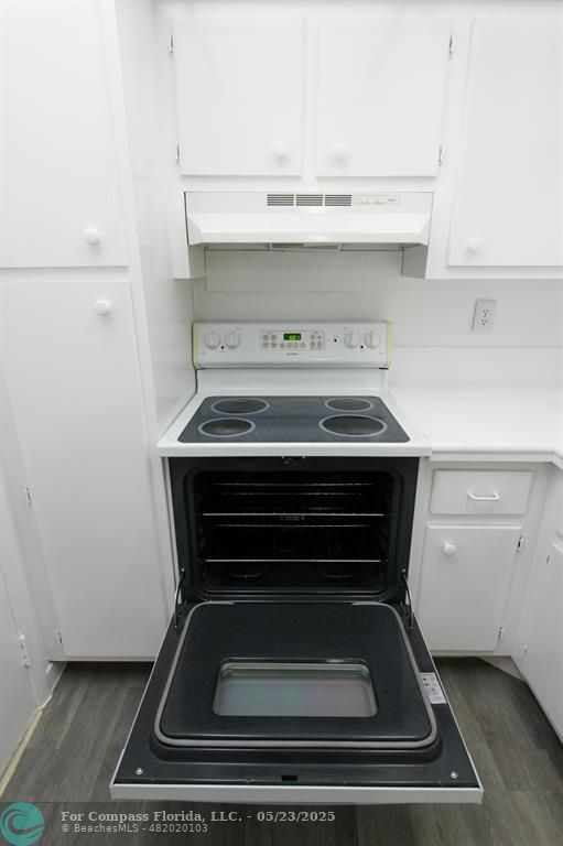 9159 Southwest 77th Avenue, Unit 411 Miami, FL 33156 - Photo 5 of 18 a stove top oven sitting inside of a kitchen