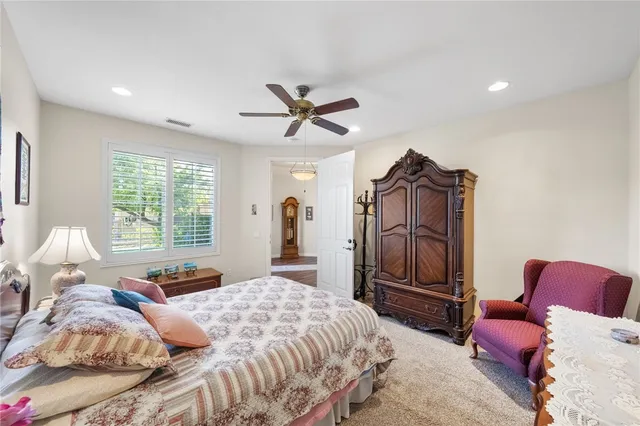 a view of a patio with a table and chairs under an umbrella