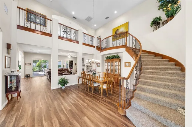 a view of a hallway with wooden floor and stairs