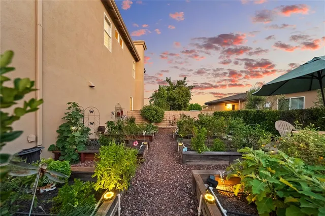 a front view of a house with a yard and potted plants