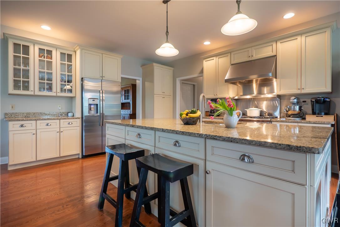 321 Meyer Road Nazareth, PA 18064 - Photo 5 of 44 a kitchen with stainless steel appliances granite countertop white cabinets and wooden floor