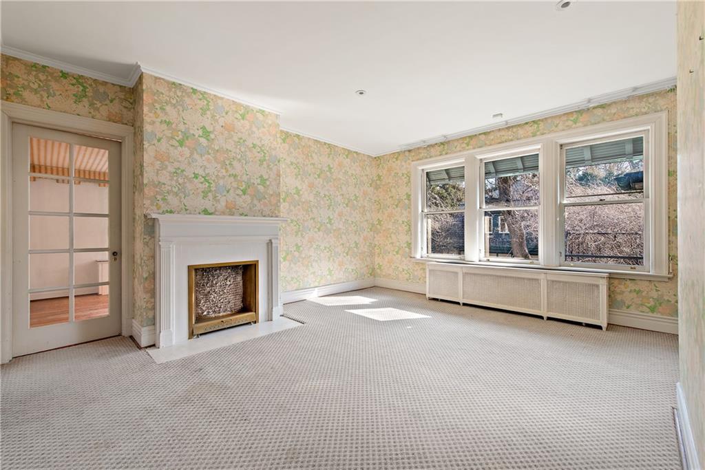 1045 Devon Road Pittsburgh, PA 15213 - Photo 21 of 25 a view of an empty room with a fireplace and a window