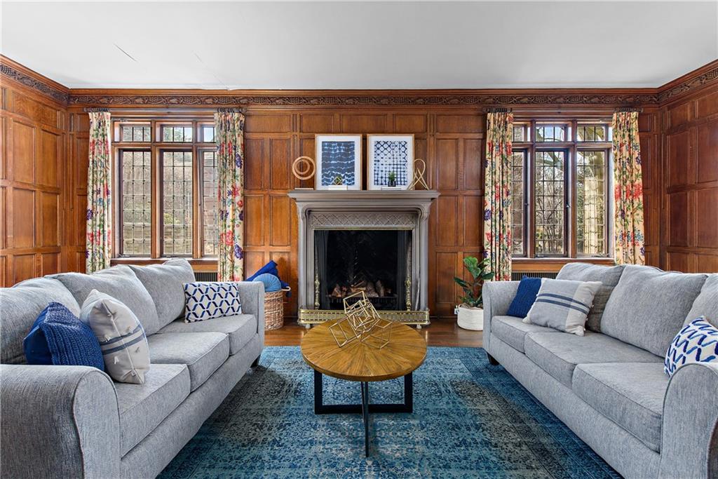 1045 Devon Road Pittsburgh, PA 15213 - Photo 7 of 25 a living room with furniture a rug and a fireplace