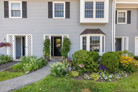a front view of a house with garden and porch