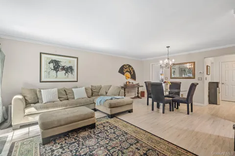 a living room with furniture dining area and a window