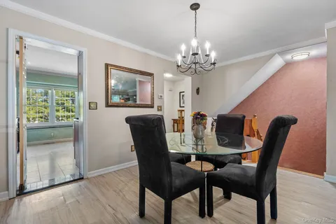 a view of a dining room with furniture and window
