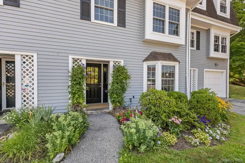 a front view of a house with garden and porch