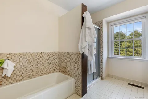 a bathroom with a bathtub and a shower