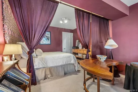 a bedroom with furniture and a chandelier