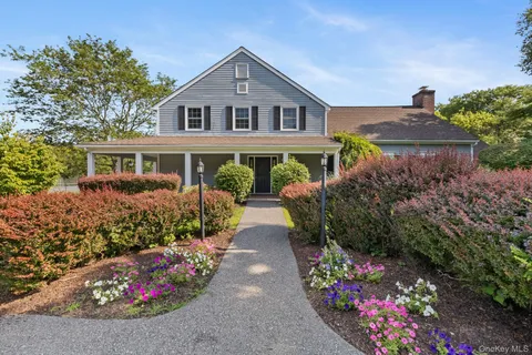 a front view of a house with a yard and fountain
