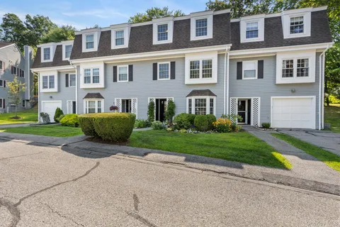 a view of a brick building next to a yard