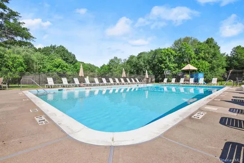 a view of a swimming pool with a yard