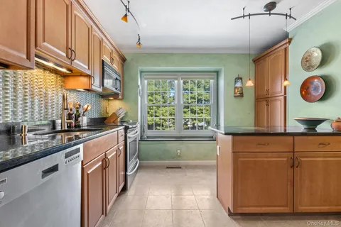 a kitchen with a sink and wooden cabinets