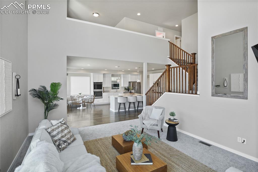 11848 Alydar Loop Colorado Springs, CO 80921 - Photo 17 of 50 Living area featuring stairway, recessed lighting, baseboards, and a towering ceiling
