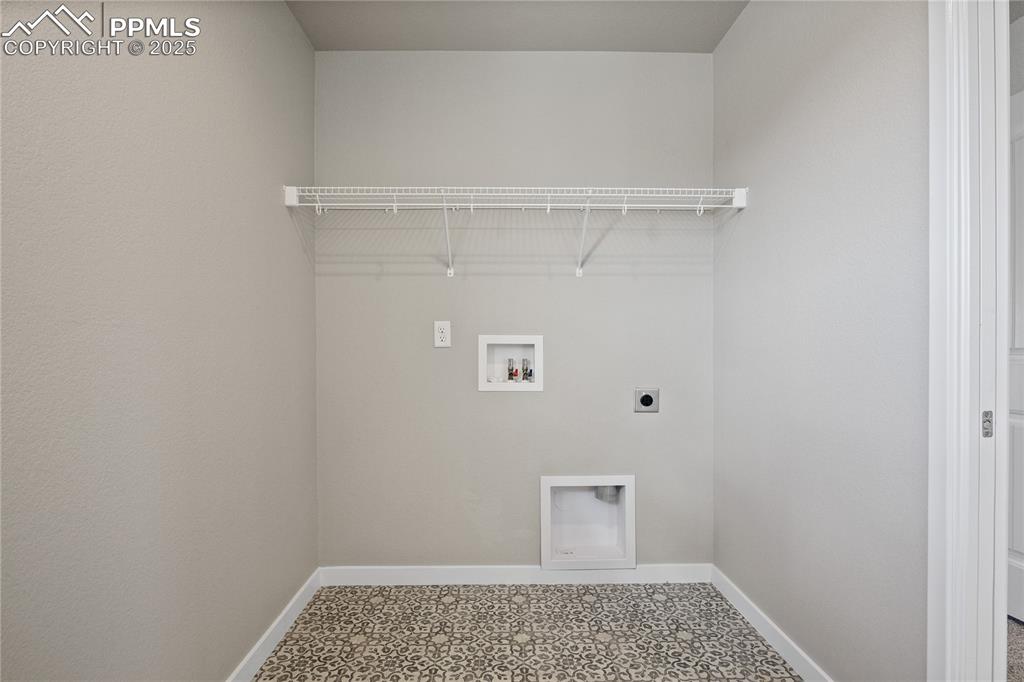 11848 Alydar Loop Colorado Springs, CO 80921 - Photo 26 of 50 Washroom with electric dryer hookup, hookup for a washing machine, and baseboards