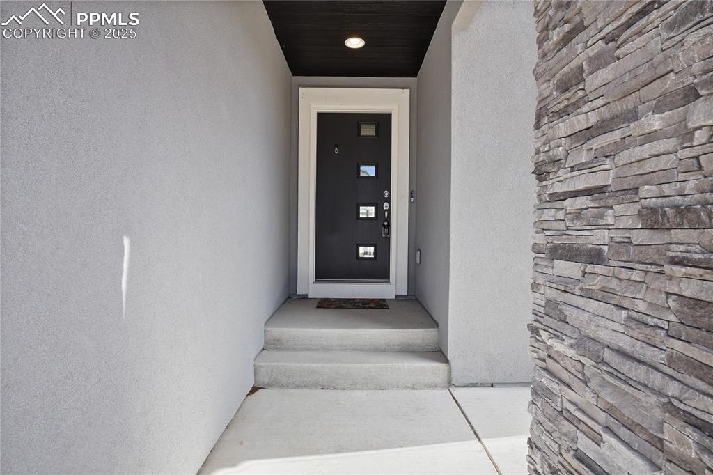 11848 Alydar Loop Colorado Springs, CO 80921 - Photo 3 of 50 Property entrance with stucco siding
