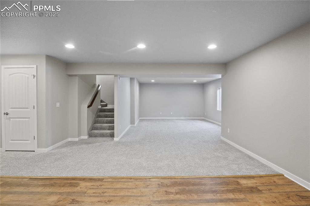 11848 Alydar Loop Colorado Springs, CO 80921 - Photo 39 of 50 Basement with baseboards, stairway, recessed lighting, carpet flooring, and wood finished floors