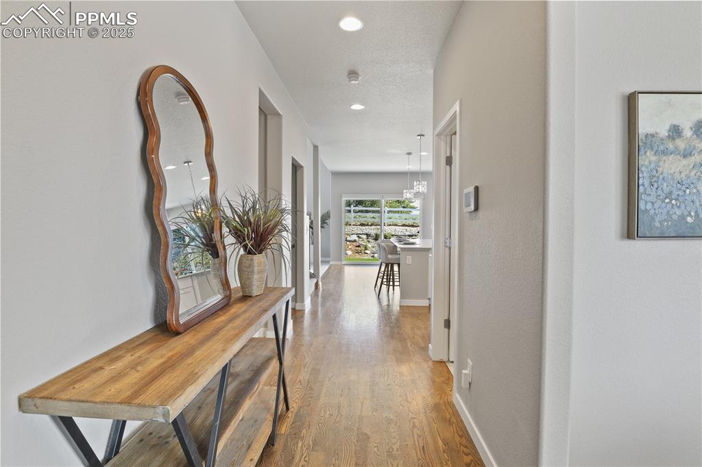 11848 Alydar Loop Colorado Springs, CO 80921 - Photo 4 of 50 Hallway featuring wood finished floors, baseboards, and recessed lighting