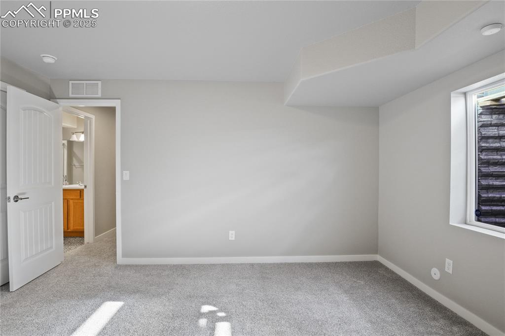 11848 Alydar Loop Colorado Springs, CO 80921 - Photo 42 of 50 Unfurnished bedroom with carpet flooring and baseboards