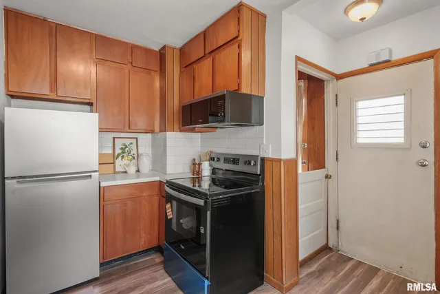 a kitchen with a refrigerator stove and microwave