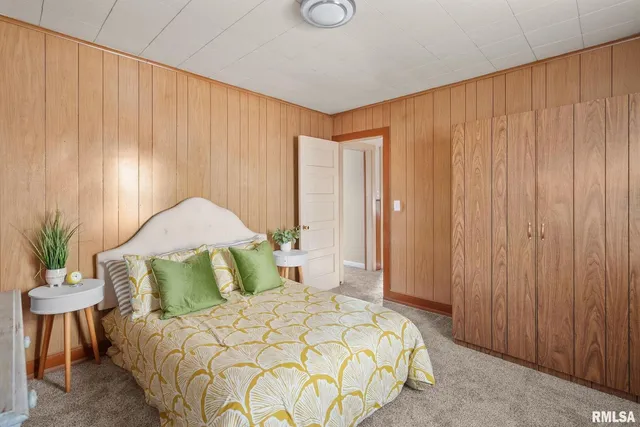 a bedroom with a bed and a table chair