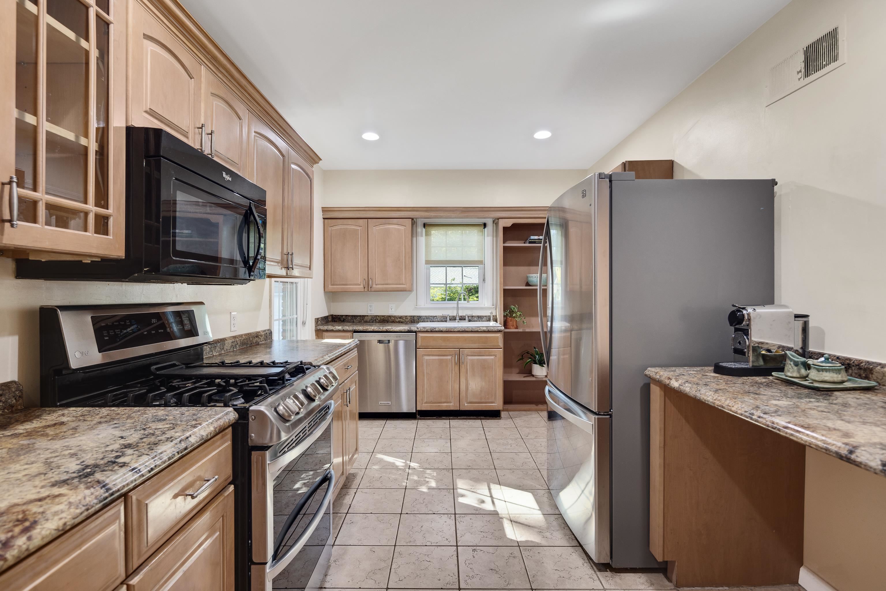 73 North Goodlett Street Memphis, TN 38117 - Photo 13 of 36 a kitchen with stainless steel appliances kitchen island granite countertop a stove sink and microwave